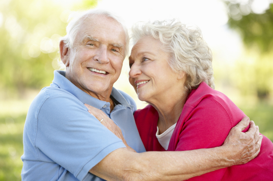 Smiling couple with dental implants near Ashville, AL